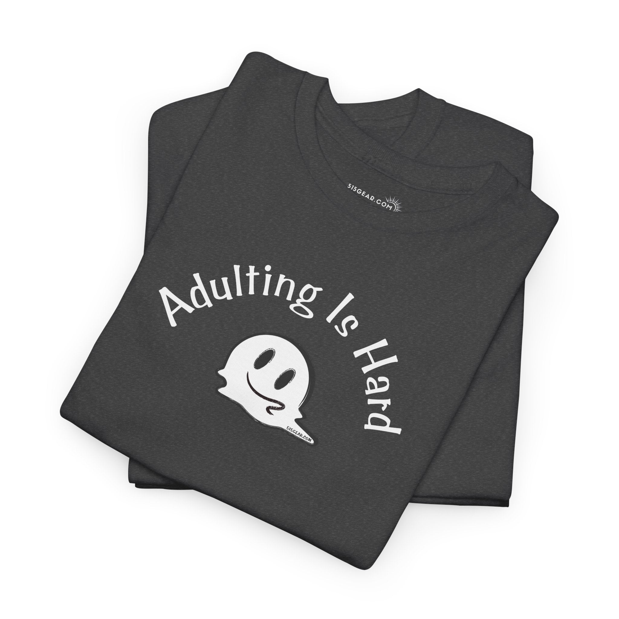 Folded black t-shirt with 'Adulting is Hard' text and ghost graphic on a white background