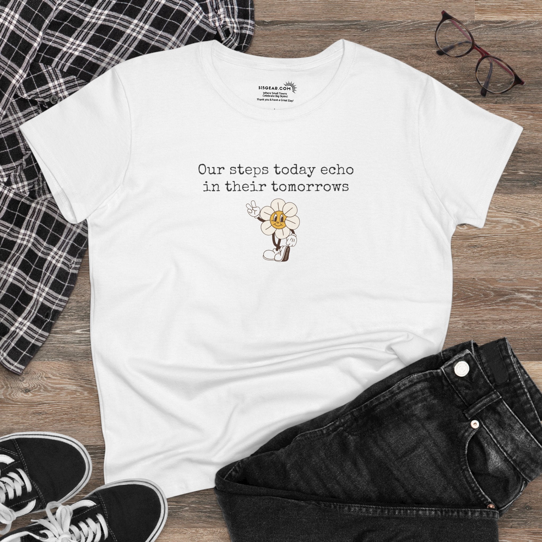 White Women's t-shirt with text "Our steps today echo in their tomorrows" and anthropomorphic hippy flower giving the peace sign graphic