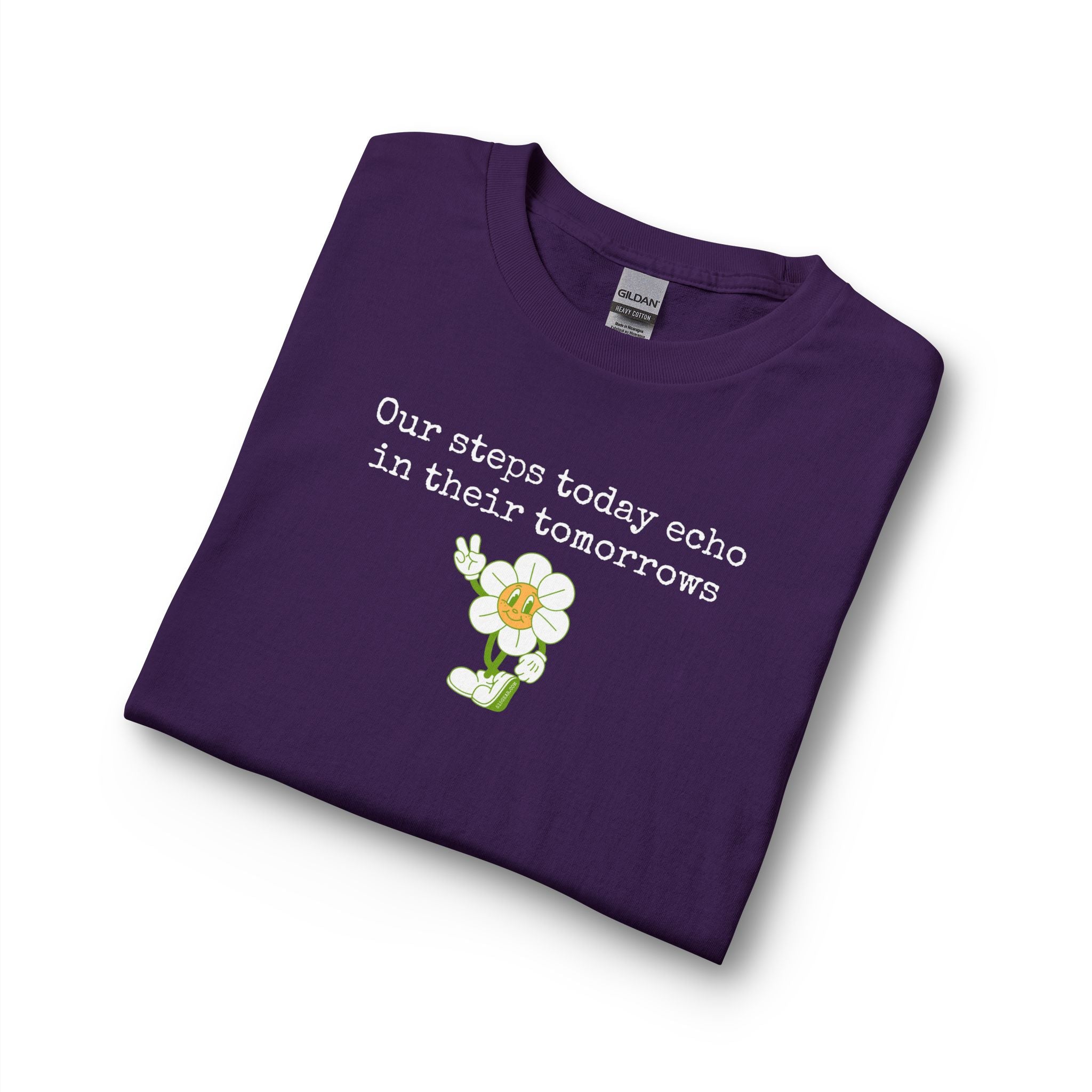 Folded purple long sleeve t-shirt with a sunflower design and text "our steps today echo in their tomorrows"