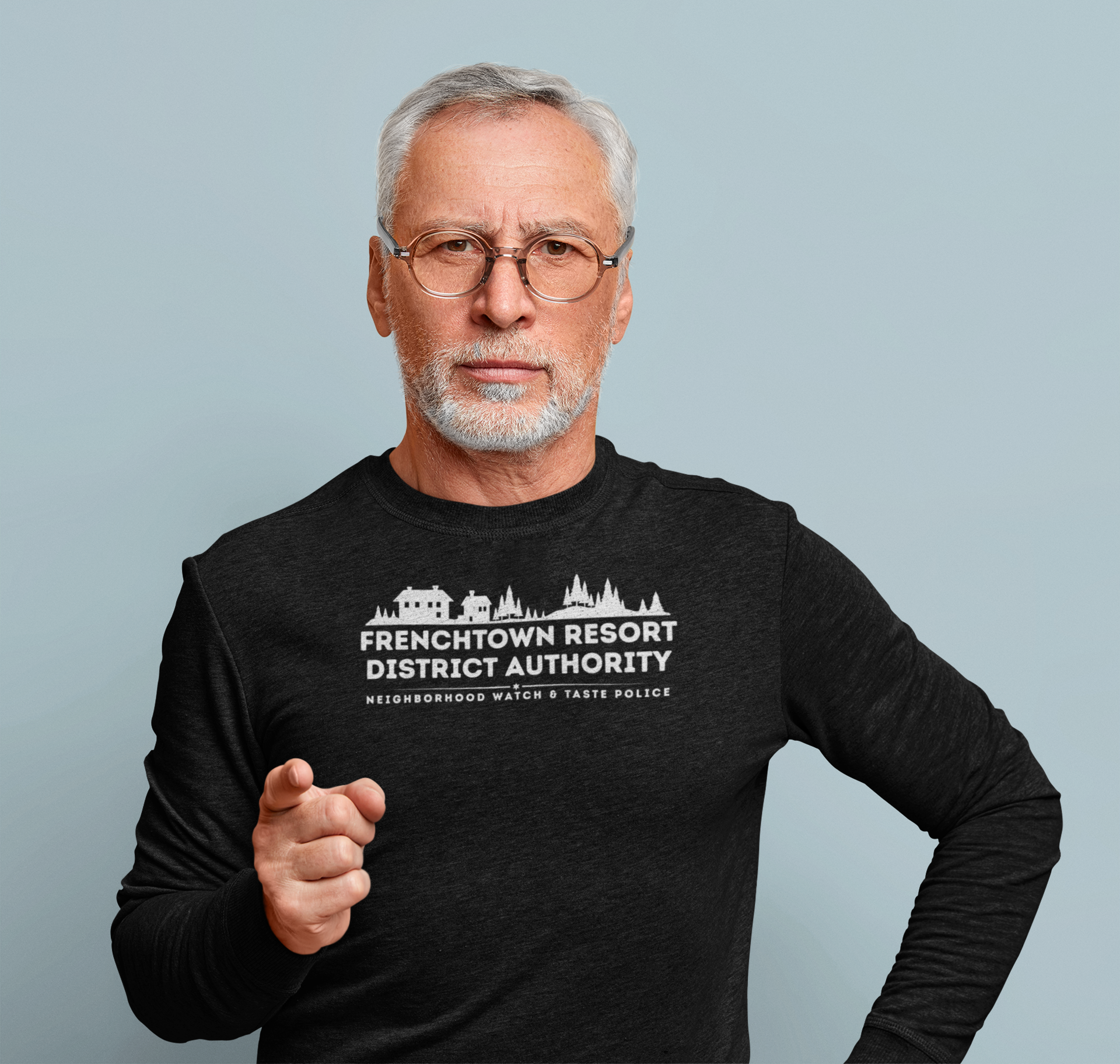 Man wearing a black Comfort Colors long-sleeve tee with text Frenchtown Resort District Authority Neighborhood Watch & Taste Police