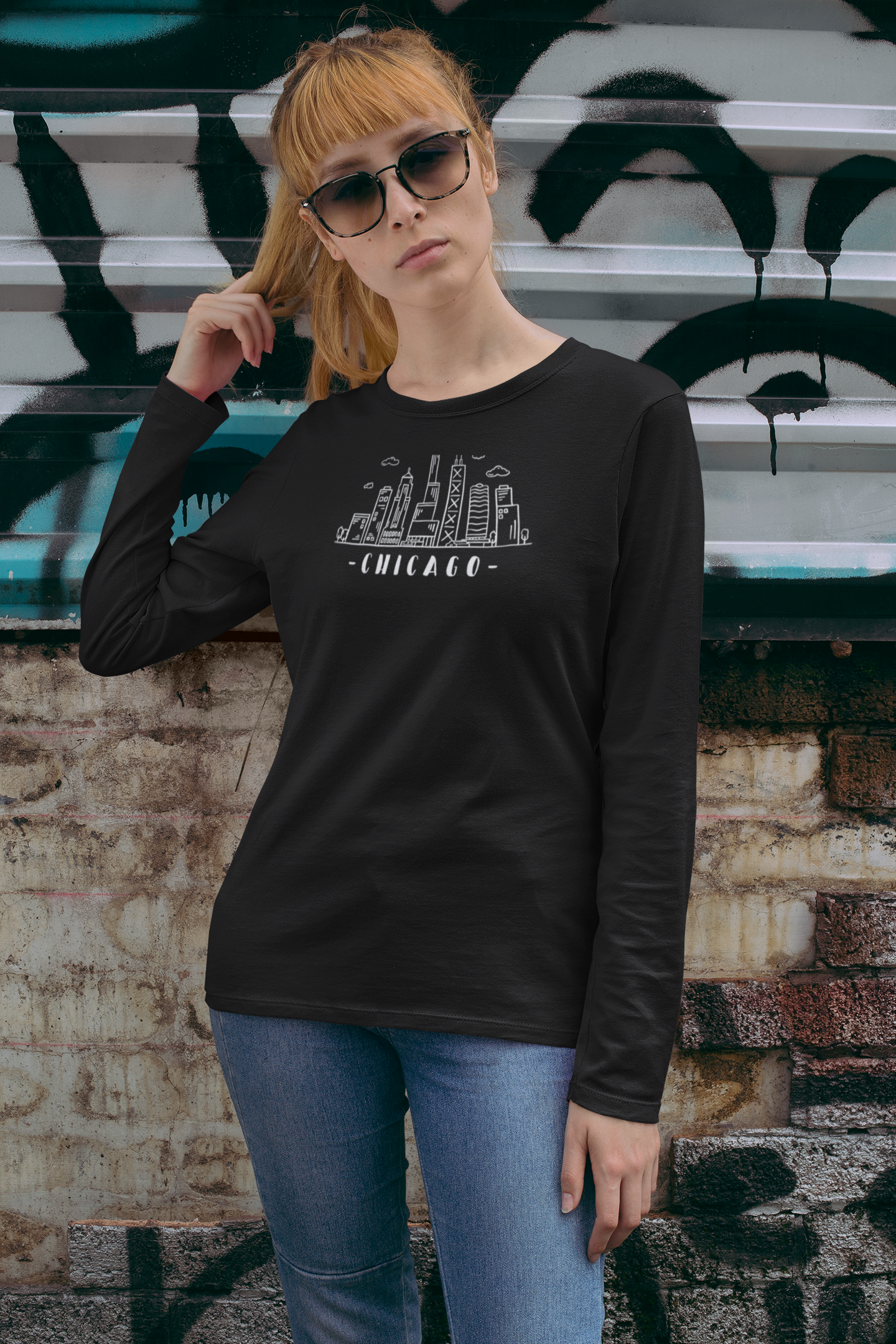 Woman wearing a black long-sleeve shirt with Chicago skyline design against and text "Chicago"