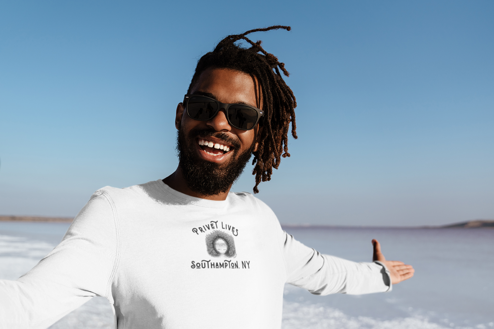 Man wearing a white long-sleeve t-shirt with Privet and Beach Pathway graphic and text "Privet Lives - Southampton, NY"