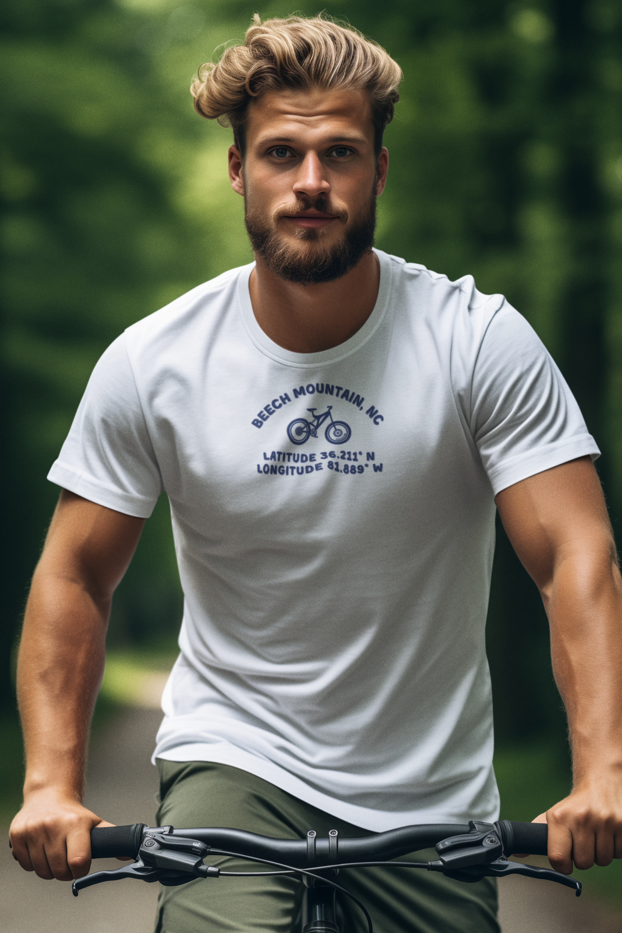 Man riding a bike wearing a white t-shirt with mountain bike graphic and text "Beech Mountain, NC - Latitude and Longitude" coordinates