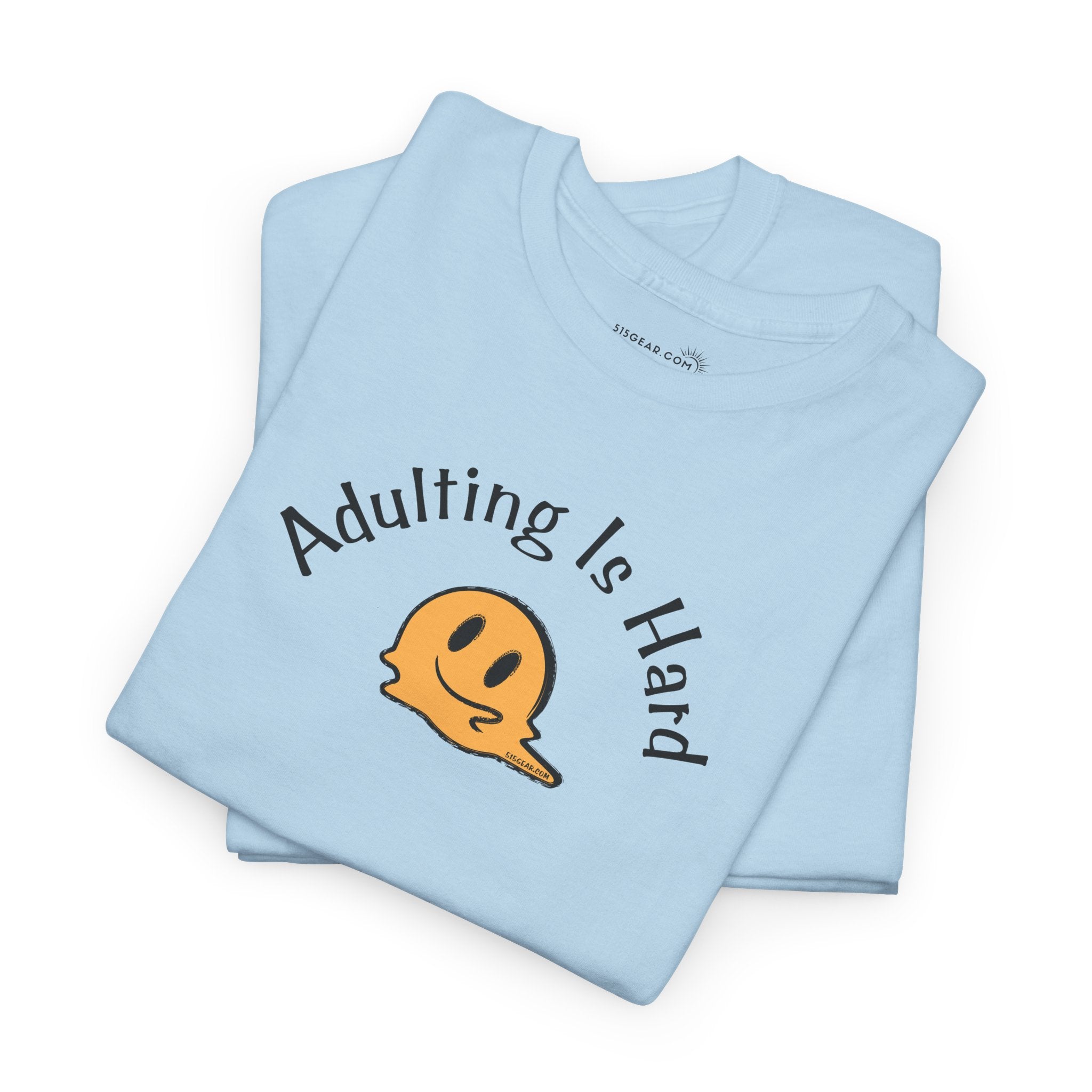 Light blue t-shirt with 'Adulting Is Hard' text and smiley face graphic on a white background