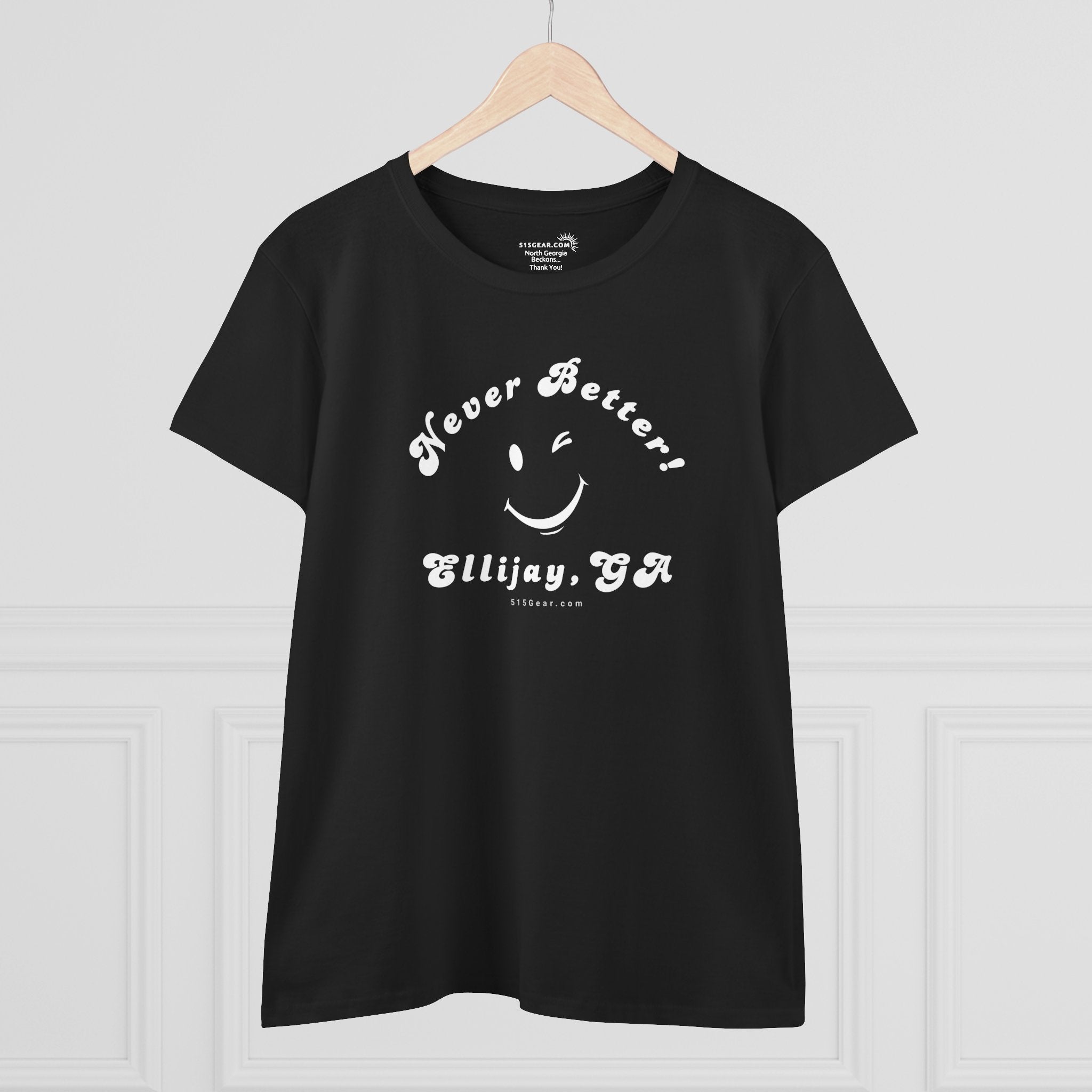 Black t-shirt with white text and smiley face on a hanger against a white background