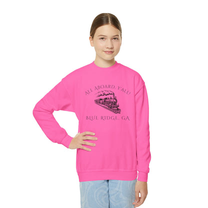 Person wearing a pink sweatshirt with a graphic design on a white background