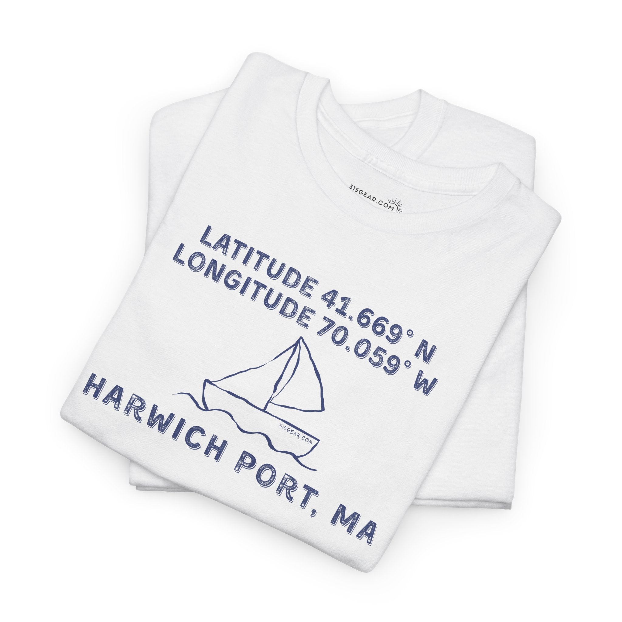Folded white t-shirt with blue text "Latitude 41.669 N Longitude 70.058 W - Harwich Port, MA" and sailboat graphic