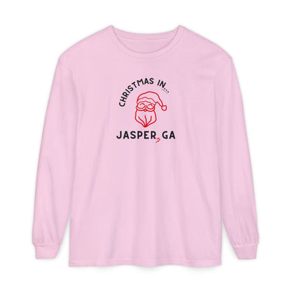 Pink long-sleeve shirt with happy Santa and candy cane graphic and text "Christmas in... Jasper, GA"