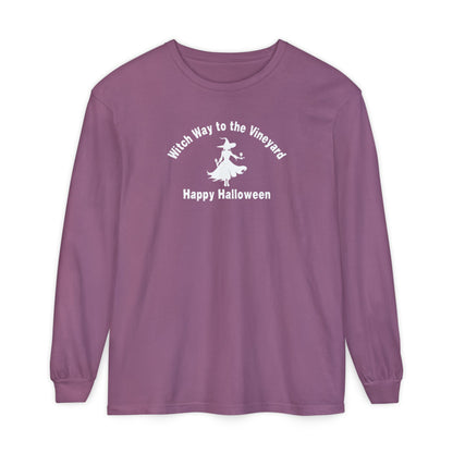 Purple long-sleeve unisex comfort color t-shirt with halloween witch graphic holding a wine glass  and text "Witch Way to the Vineyard - Happy Halloween" 