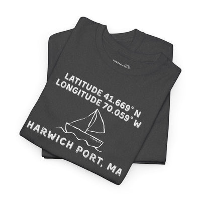 Folded black t-shirt with text "Latitude 41.669 N Longitude 70.058 W - Harwich Port, MA" and sailboat graphic