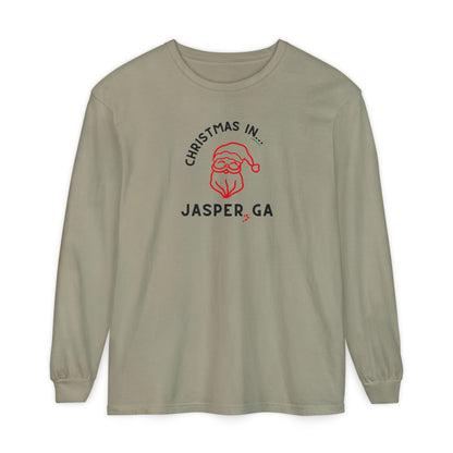 Sandstone long-sleeve shirt with happy Santa and candy cane graphic and text "Christmas in... Jasper, GA"