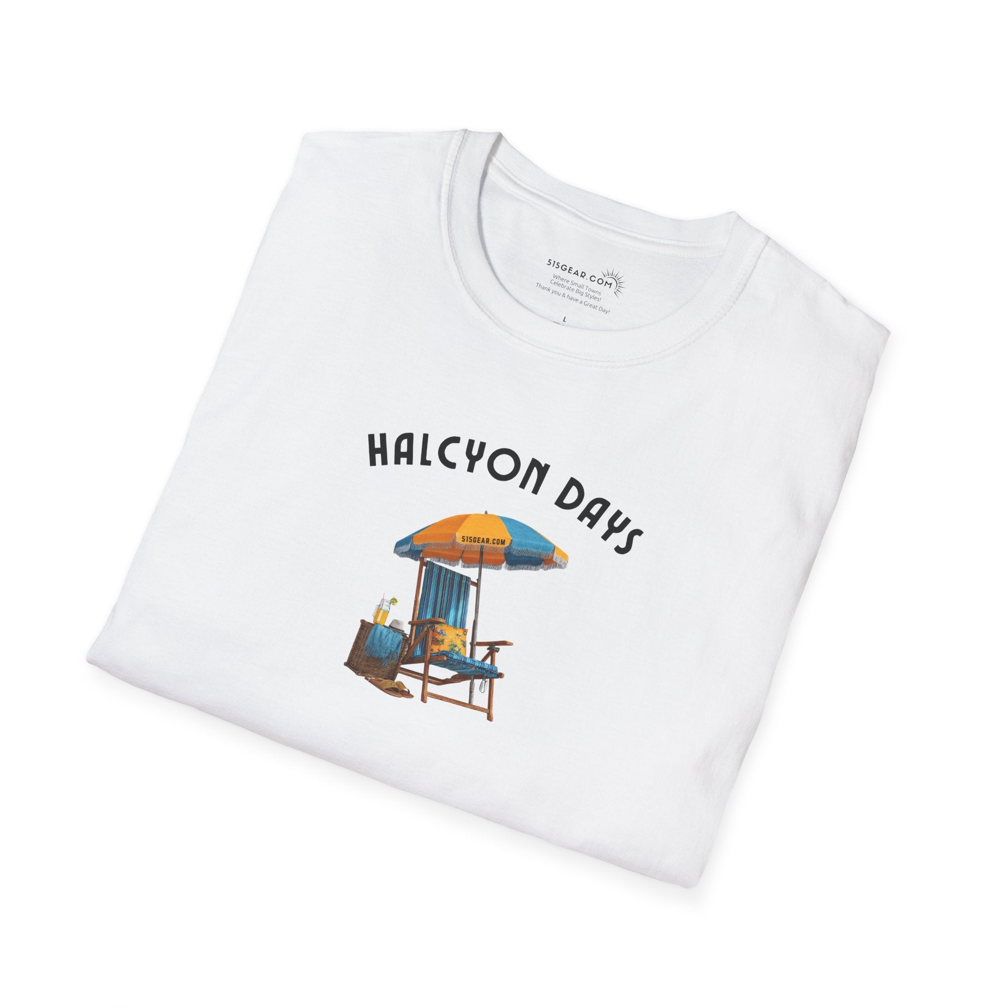 Folded White unisex t-shirt with text "Halcyon Days" and beach chair with umbrella graphic