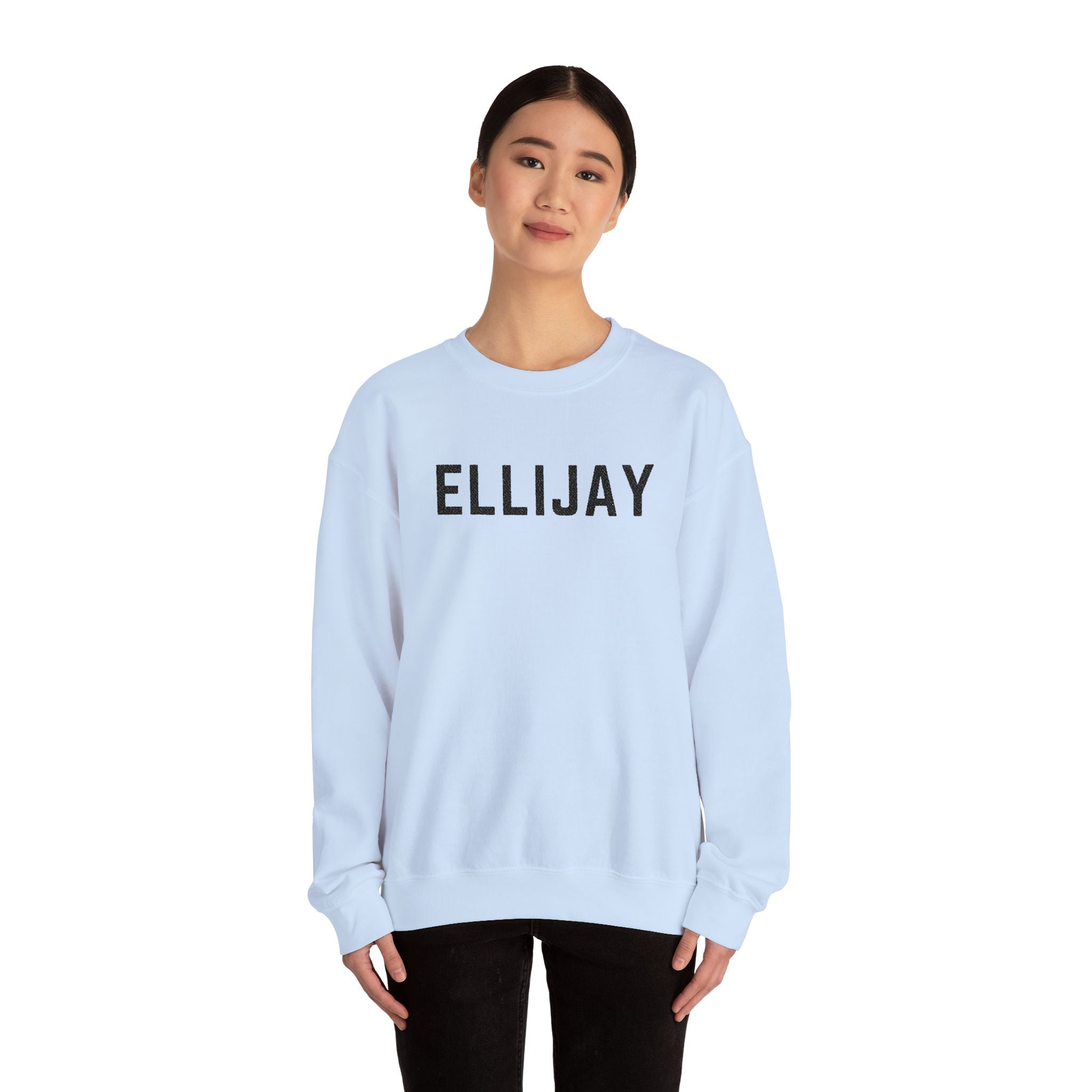 Person wearing a light blue sweatshirt with 'ELLIJAY' embroidered on it against a white background