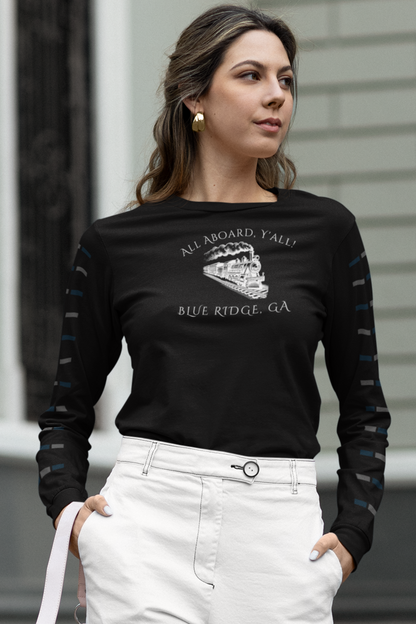 Woman wearing a black long-sleeve shirt with train graphic and text "All Aboard, Y'all - Blue Ridge, GA" standing outdoors.