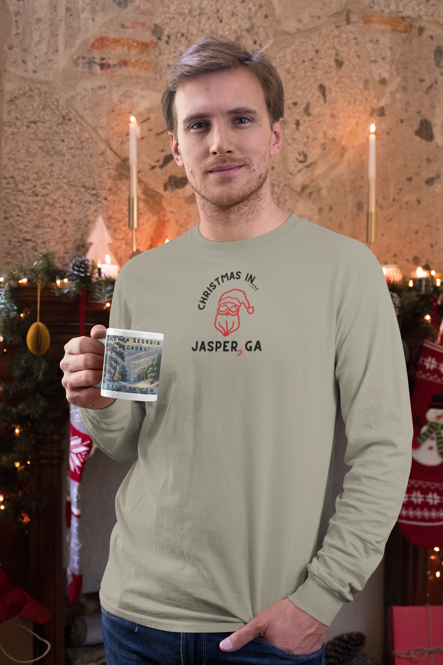 Man wearing a long-sleeve shirt with happy Santa graphic and text 'Christmas in Jasper, GA' design, holding a mug.