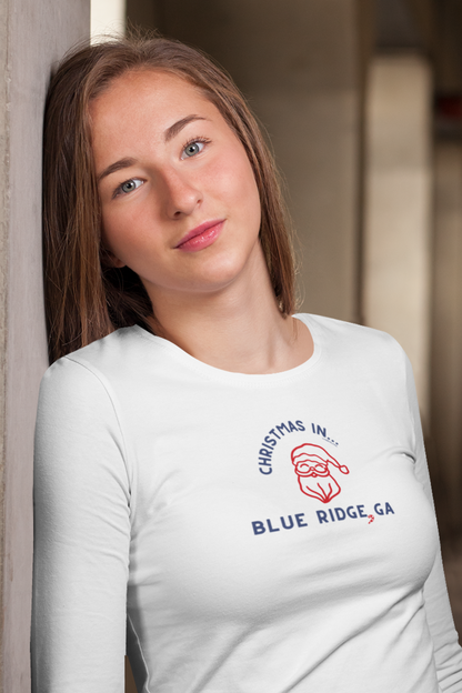 Woman wearing a white long-sleeve shirt with a Christmas in Blue Ridge, GA design.