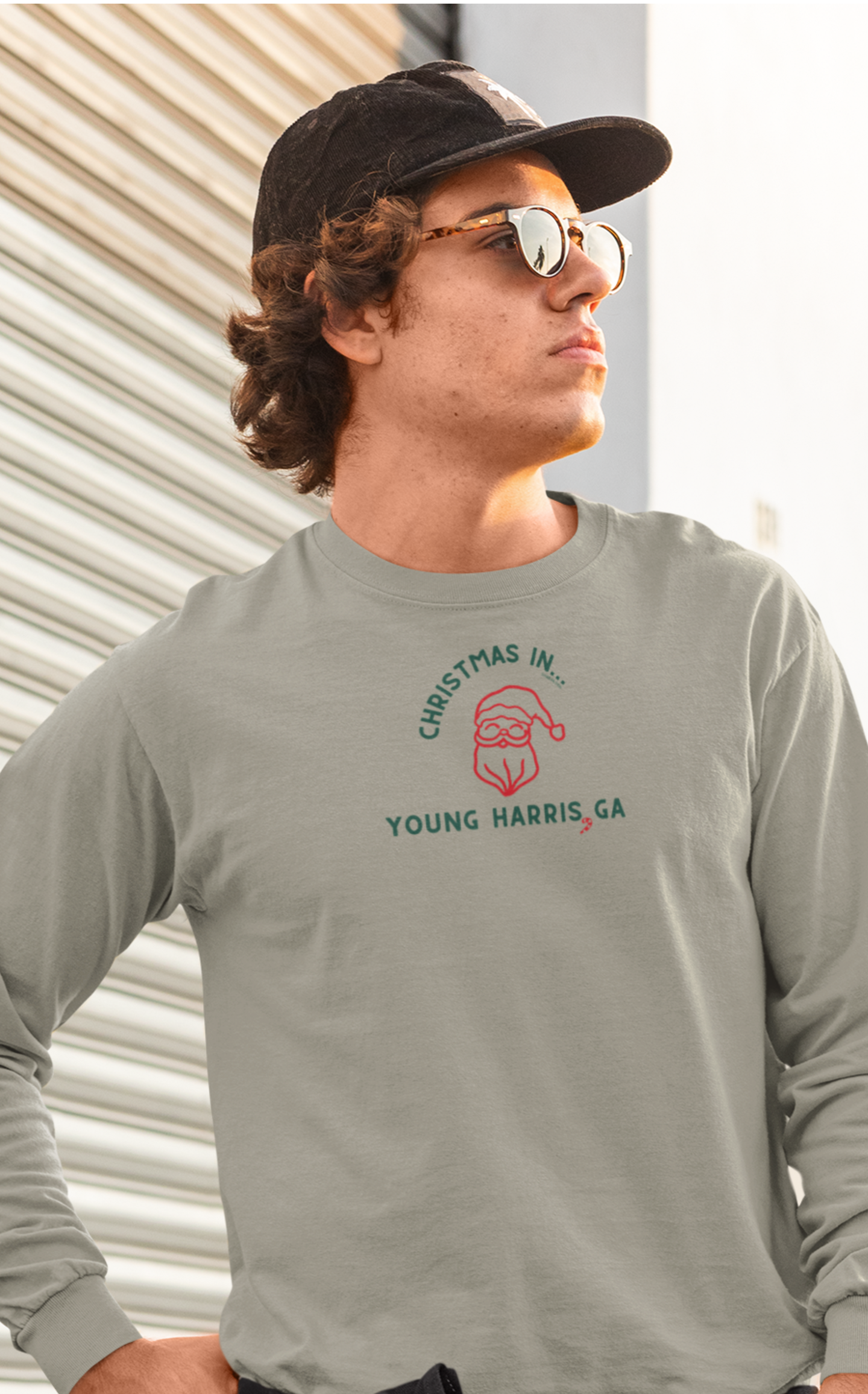 Man wearing a olive long-sleeve unisex Comfort Colors t-shirt with Christmas graphic and text "Christmas in Young Harris, GA"