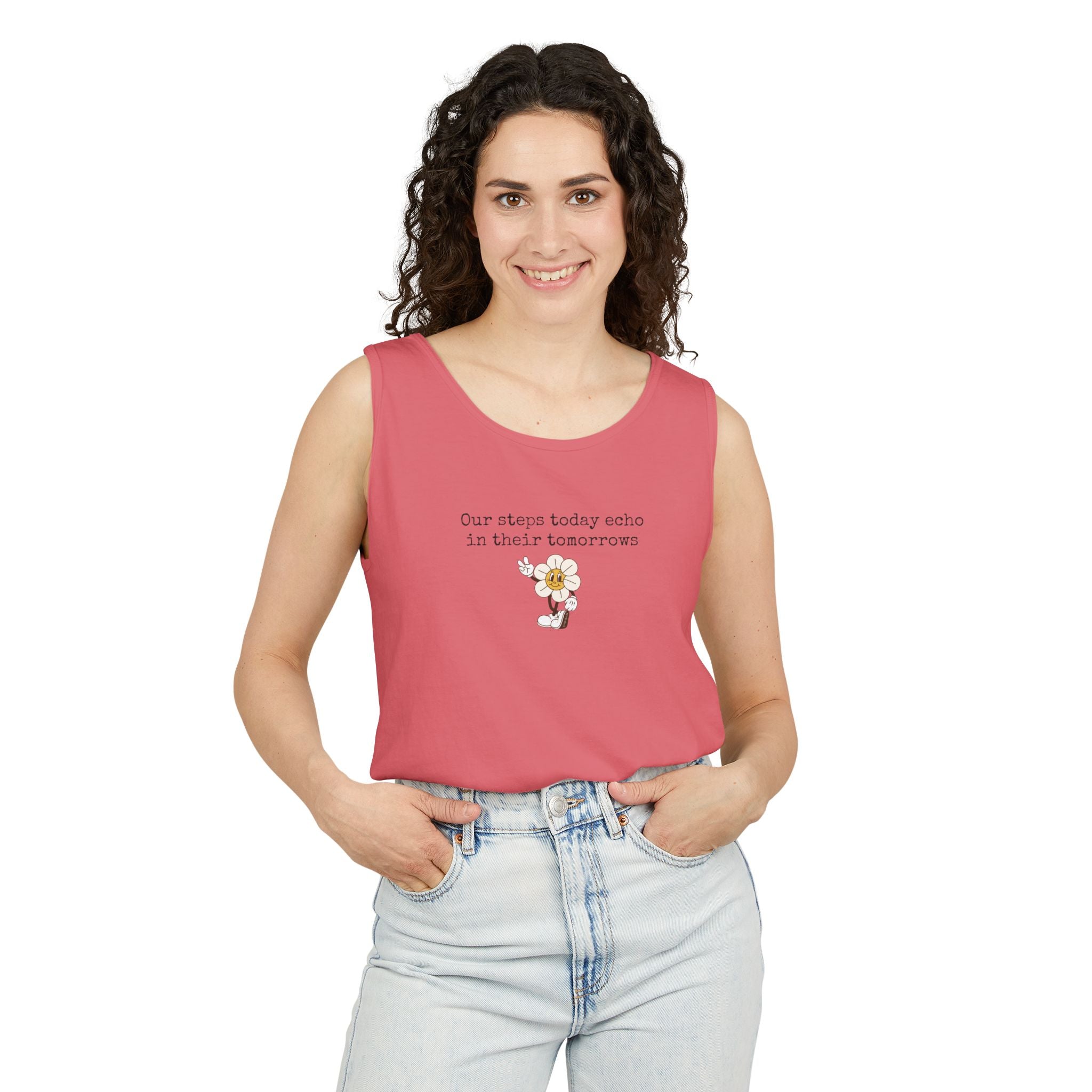 Woman wearing a pink tank top with text "Our steps today echo in their tomorrows" and anthropomorphic hippy flower graphic