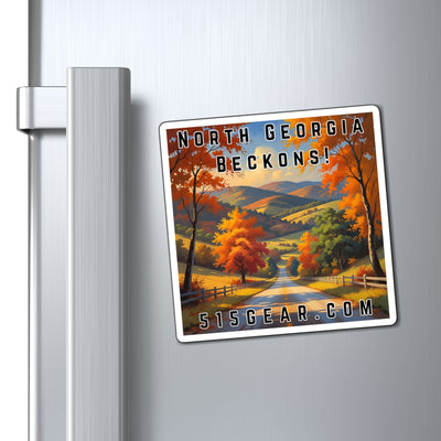 Fridge Magnet with a visual of a Road through a scenic Autumn / Fall landscape with trees and mountains, featuring text 'North Georgia Beckons!' by 515Gear.com