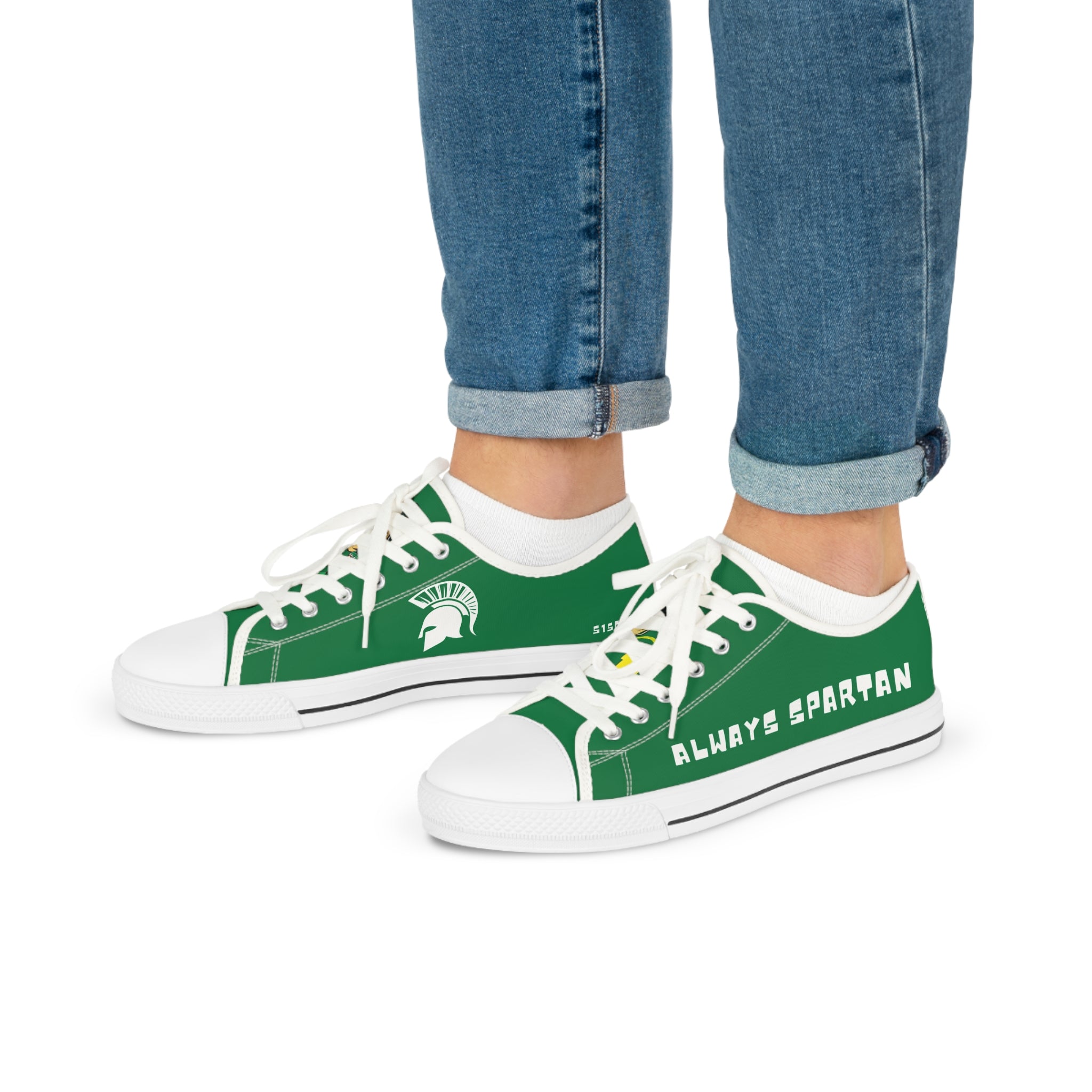 Green and white sneakers with 'Always Spartan' text worn with blue jeans on a white background