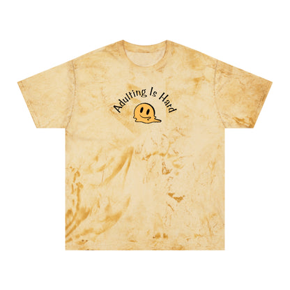 Yellow tie-dye Comfort Colors 1745 unisex color blast t-shirt, 100% ring-spun cotton, with melting smiley face and text "Adulting is Hard"