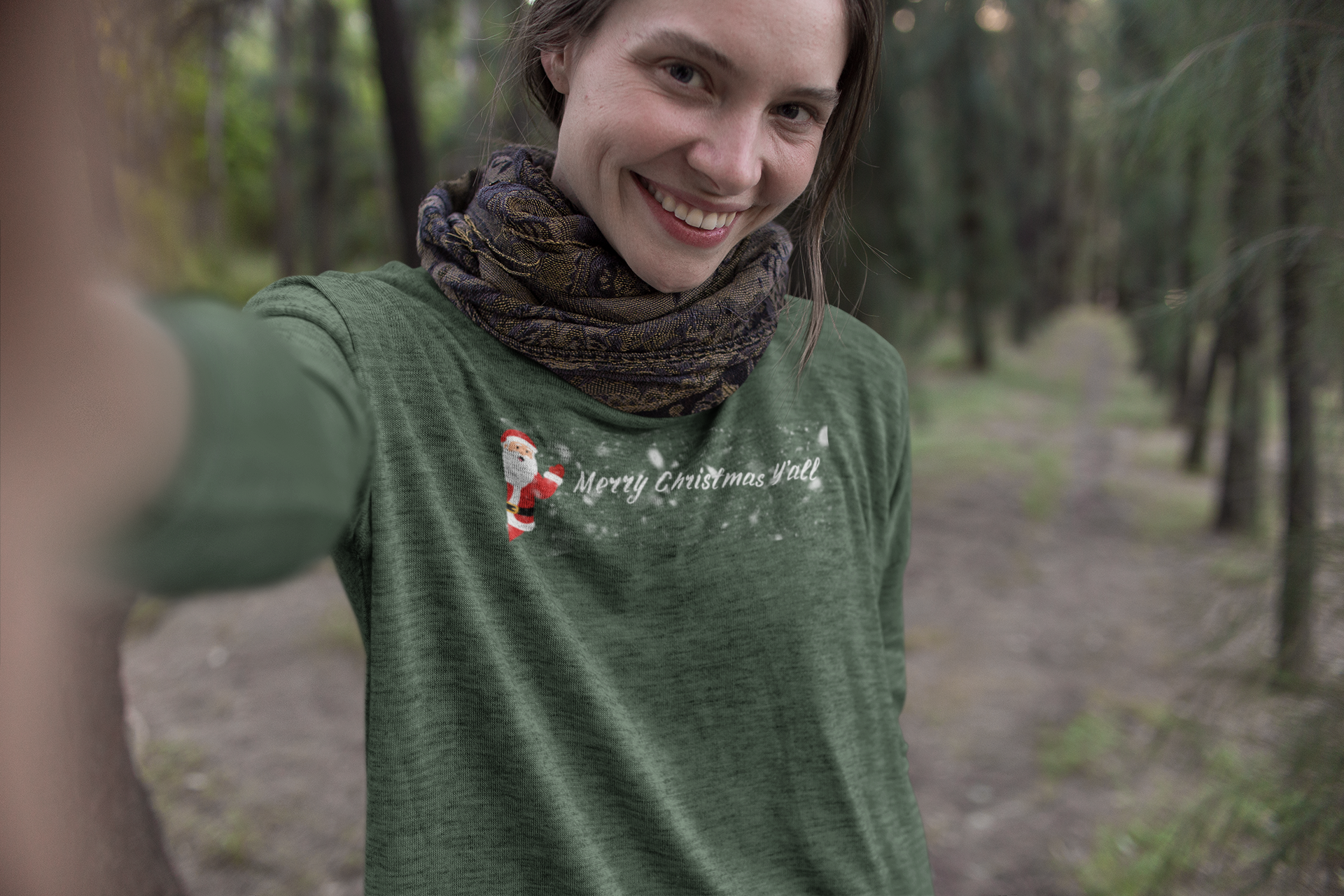 Woman in a green shirt with a printed design in a forest setting